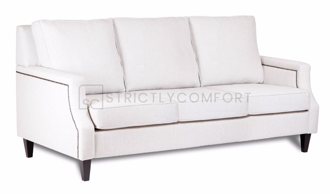 Hampton sofa featuring warwick fabric with studs