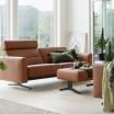 Stressless Stella Ottoman featuring Paloma New Cognac leather and Matte Black legs